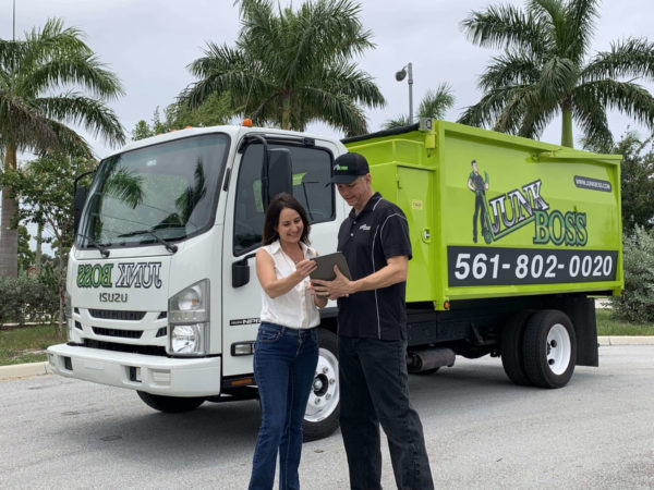 junk boss junk removal expert quoting customer for prices